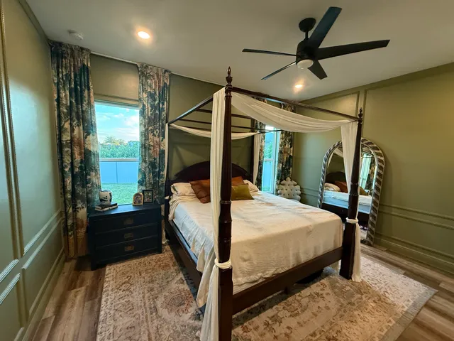 a bedroom with a bed and a mirror