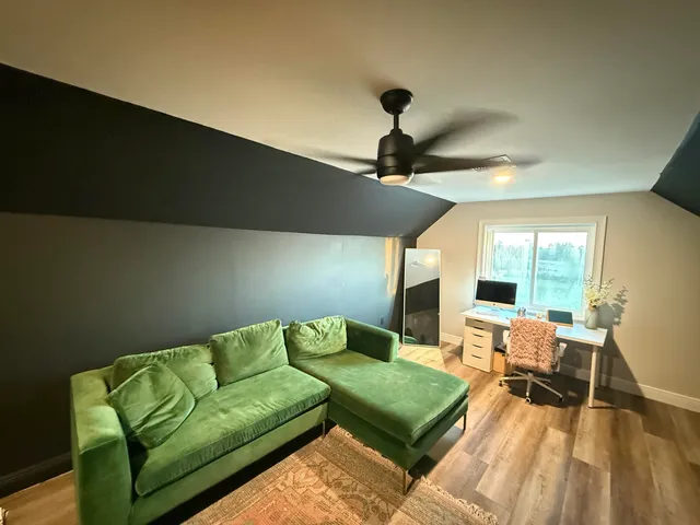 a workspace with furniture and wooden floor