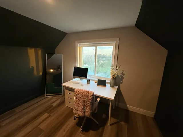 a bedroom with a bed and a ceiling fan