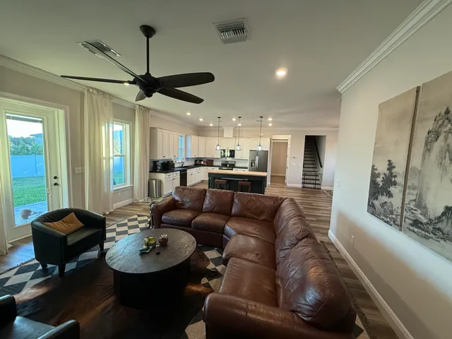 a living room with furniture and a chandelier