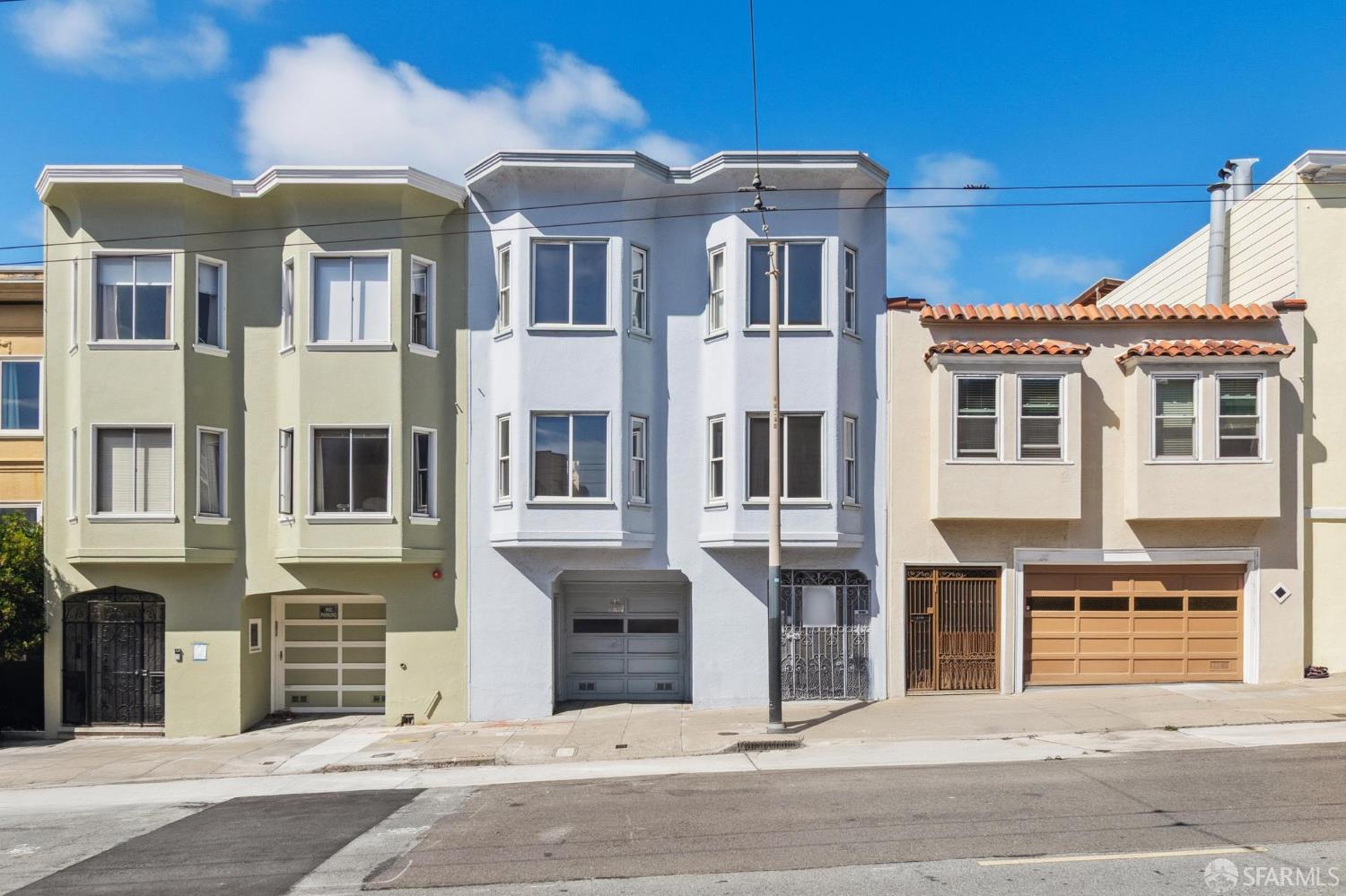 1374-1376 Chestnut Street San Francisco, CA 94123 - Photo 1 of 16 a front view of a house with a parking space