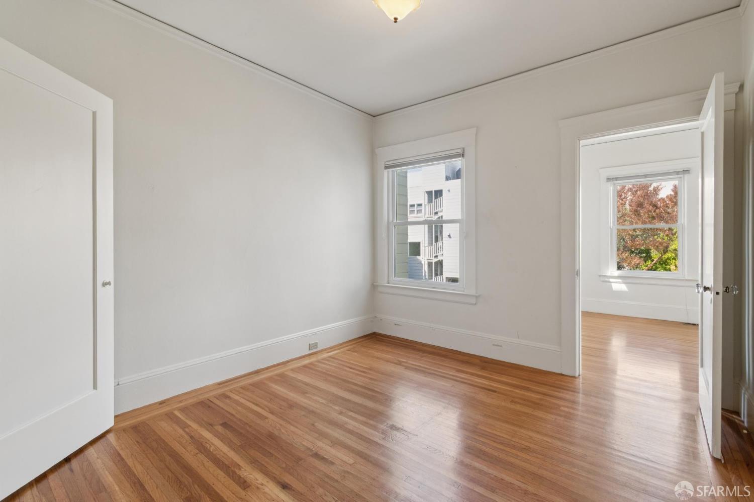 1374-1376 Chestnut Street San Francisco, CA 94123 - Photo 12 of 16 a view of an empty room with wooden floor and a window