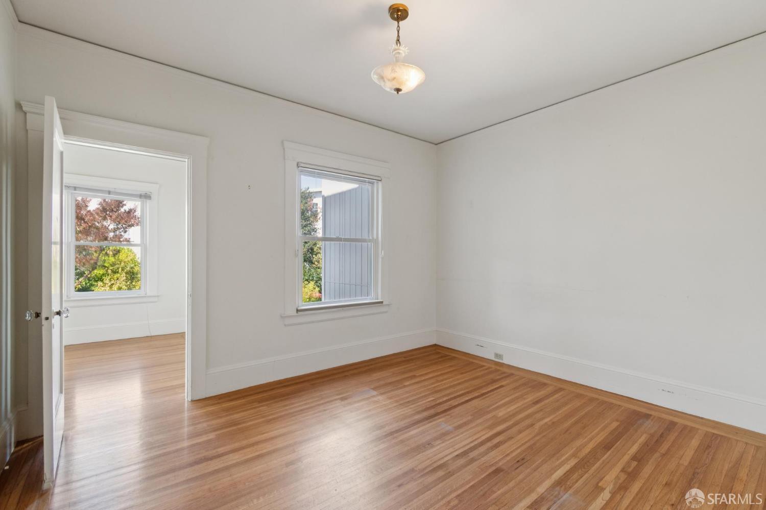 1374-1376 Chestnut Street San Francisco, CA 94123 - Photo 13 of 16 wooden floor in an empty room with a window