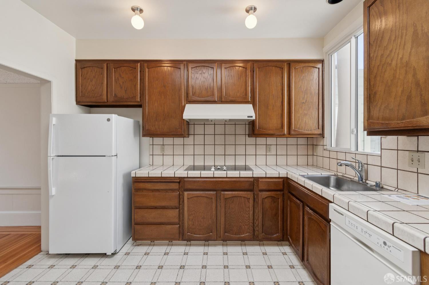 1374-1376 Chestnut Street San Francisco, CA 94123 - Photo 3 of 16 a kitchen with stainless steel appliances granite countertop a sink stove and refrigerator