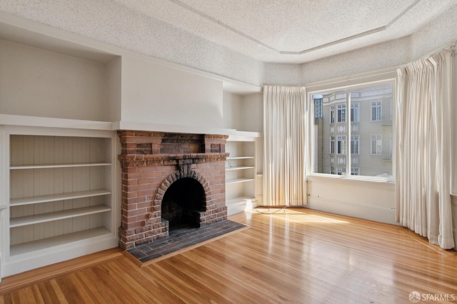 1374-1376 Chestnut Street San Francisco, CA 94123 - Photo 8 of 16 a view of an empty room with wooden floor and a window