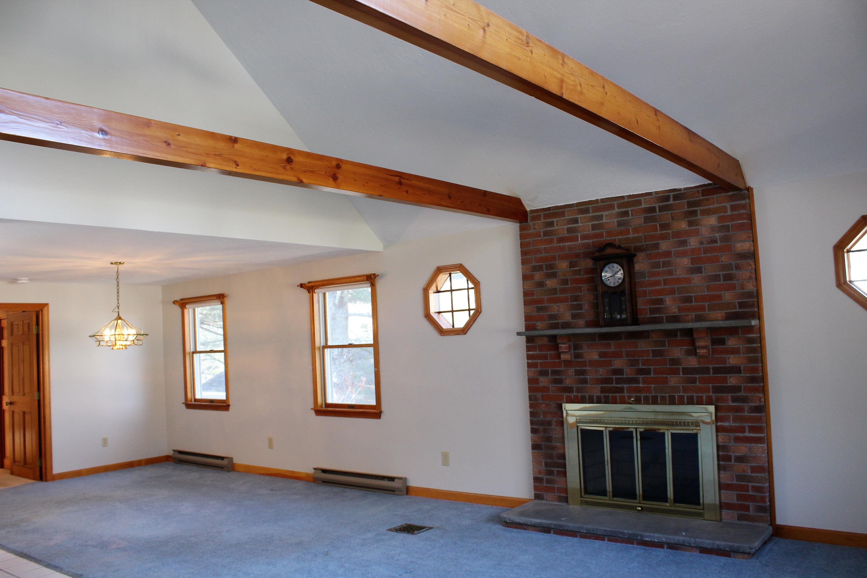 35 Catskill Road Buzzards Bay, MA 02532 - Photo 16 of 43 a living room with a fireplace and a wooden floor
