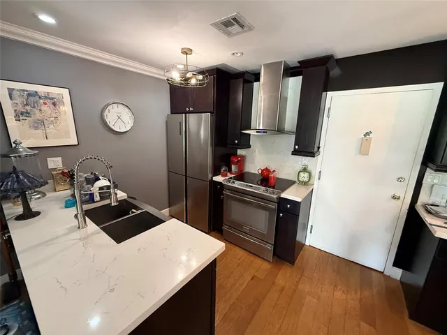 a kitchen with a table chairs and refrigerator