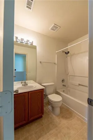 a bathroom with a sink toilet vanity and shower