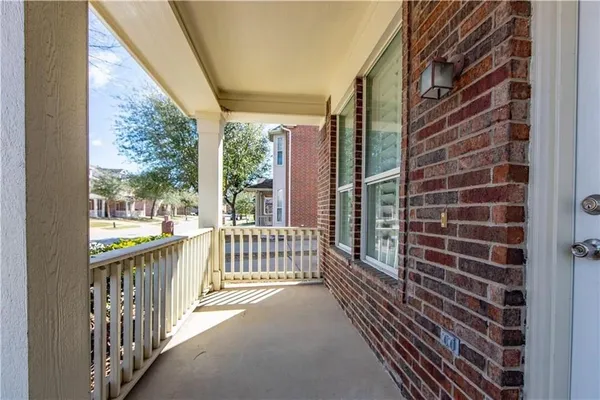 a view of a balcony with a floor to ceiling window and wooden fence
