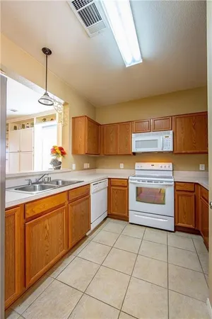 a kitchen with a stove sink and cabinets
