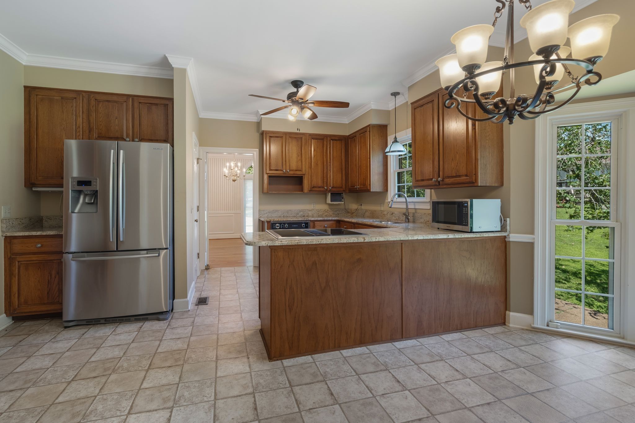 709 Heather Spring Brentwood, TN 37027 - Photo 12 of 43 a kitchen with kitchen island granite countertop a refrigerator a stove a sink and dishwasher with wooden floor