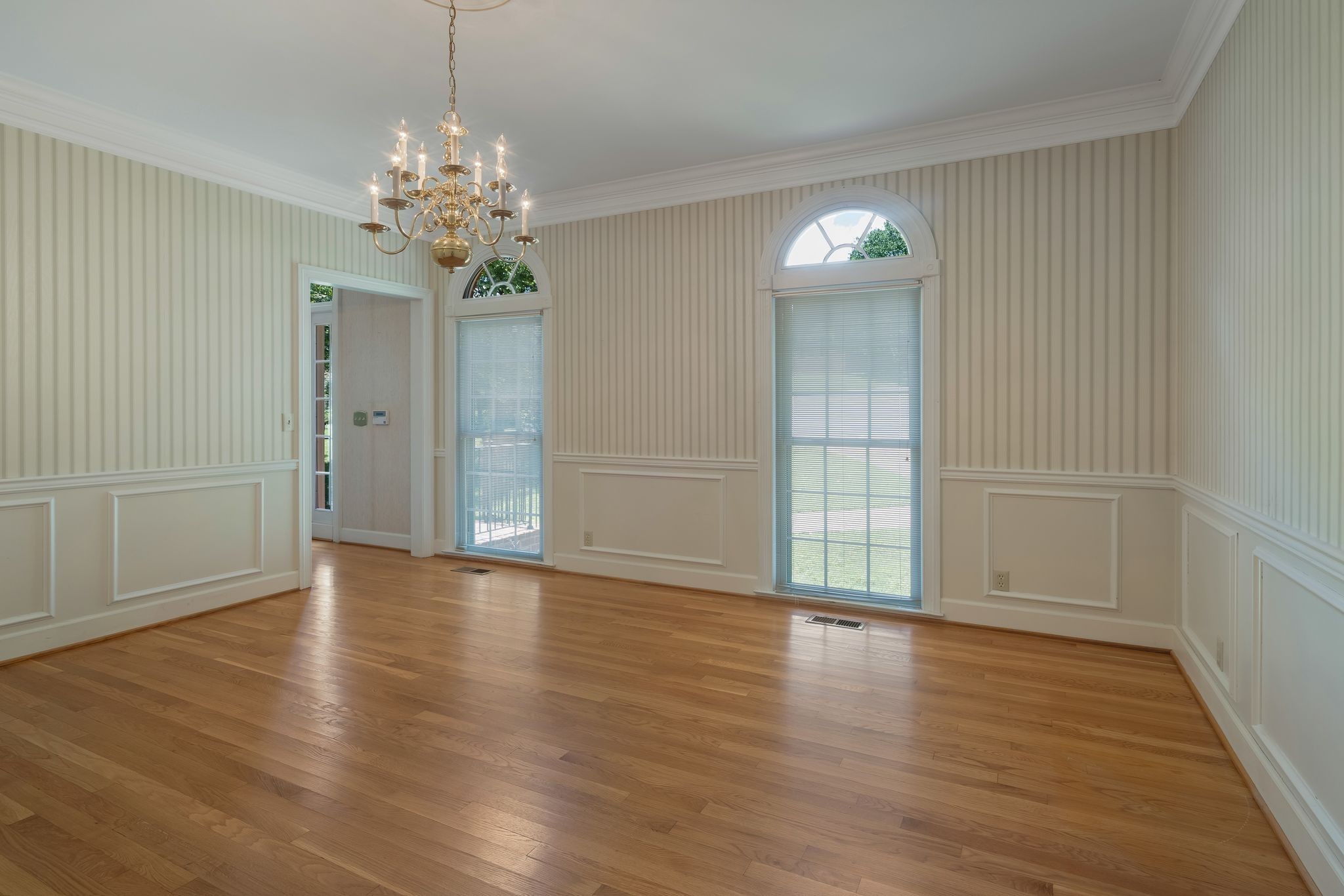 709 Heather Spring Brentwood, TN 37027 - Photo 10 of 43 a view of an empty room with wooden floor and a window