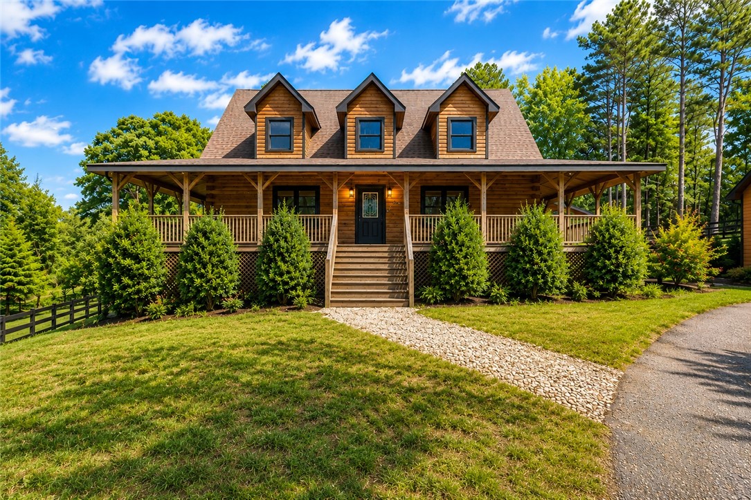 414 Devon Way Anderson, SC 29621 - Photo 42 of 50 A charming wood-sided home with a covered porch beckons amidst a lush, treed setting.
