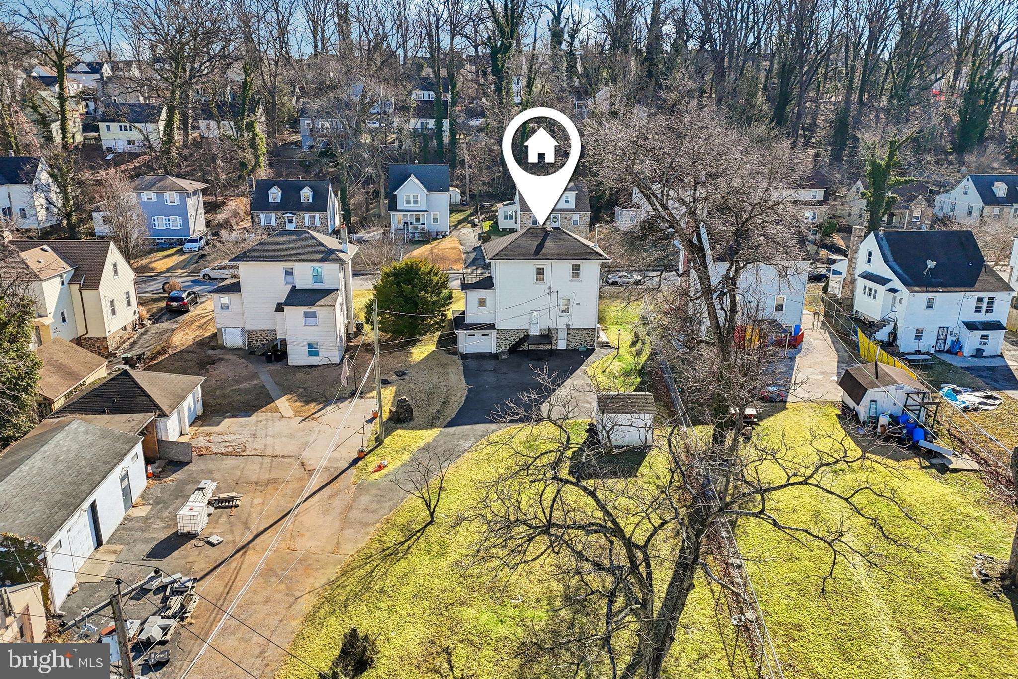 14 Summerfield Road Gwynn Oak, MD 21207 - Photo 46 of 54 an aerial view of a residential apartment building with a yard and parking spaces