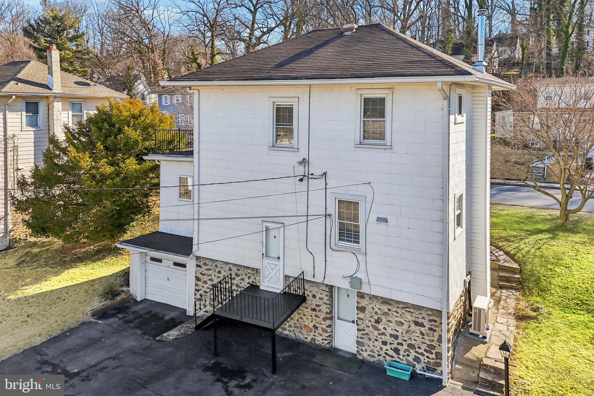 14 Summerfield Road Gwynn Oak, MD 21207 - Photo 54 of 54 a brick house with a bench and a yard in the back