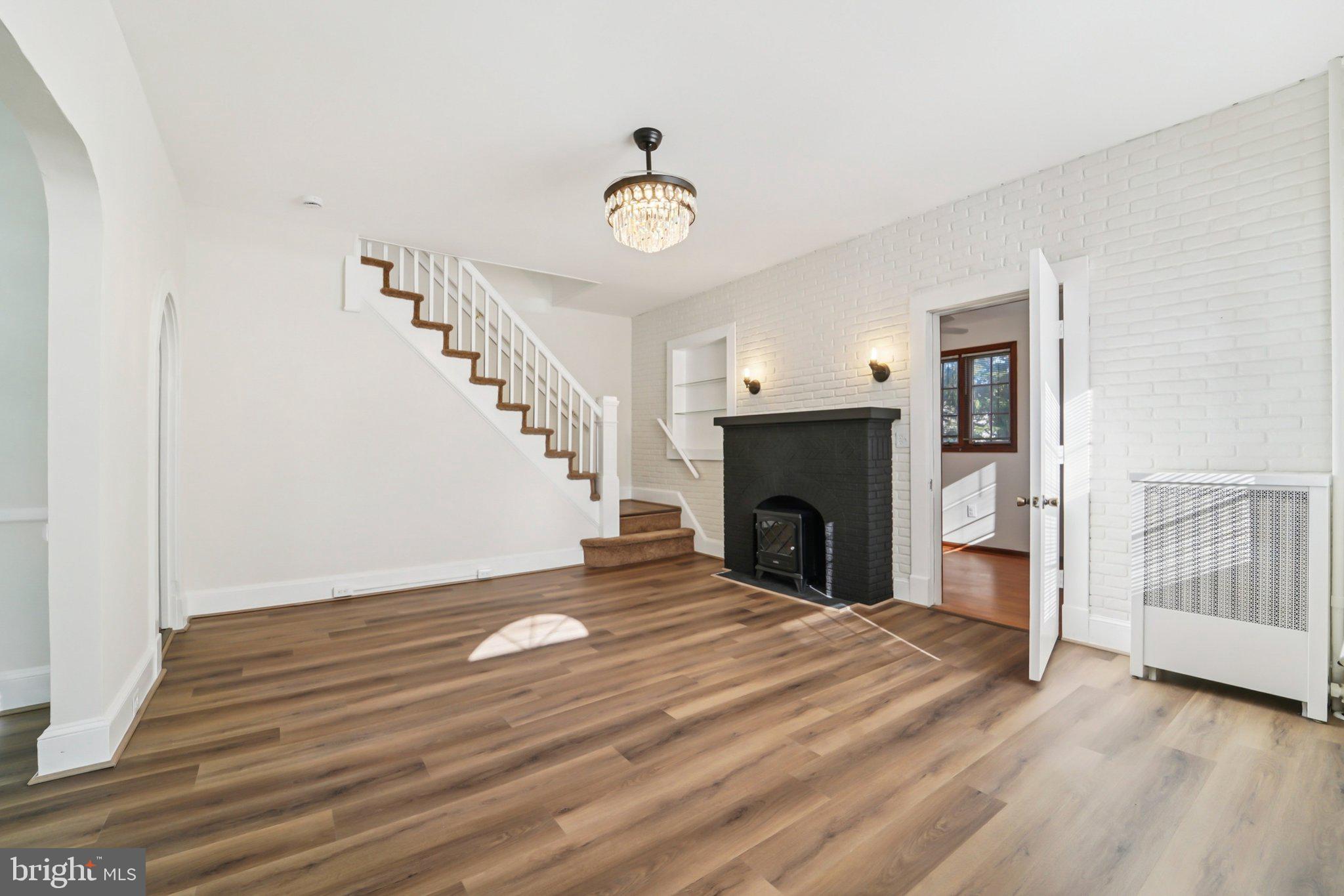 14 Summerfield Road Gwynn Oak, MD 21207 - Photo 7 of 54 a view of an empty room with wooden floor fireplace and a window