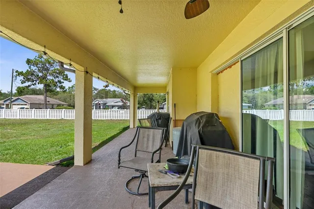 a view of a porch with furniture and backyard