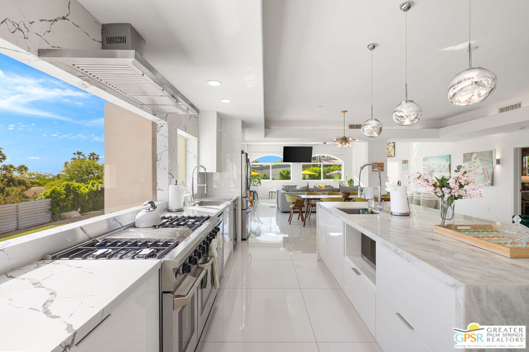 775 West Racquet Club Road Palm Springs, CA 92262 - Photo 14 of 44 a kitchen with stove and cabinets