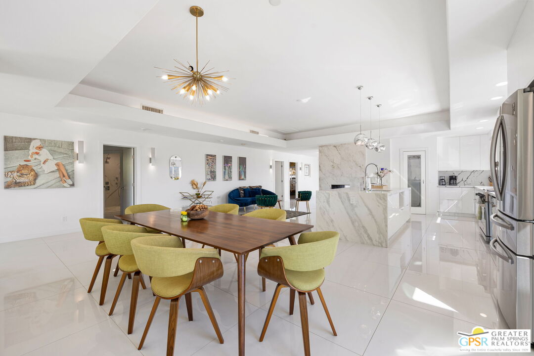 775 West Racquet Club Road Palm Springs, CA 92262 - Photo 16 of 44 a view of a dining room with furniture and a chandelier