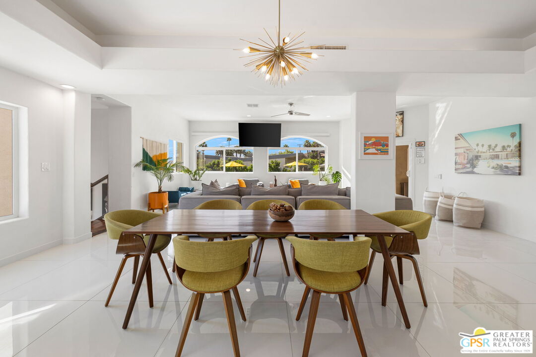 775 West Racquet Club Road Palm Springs, CA 92262 - Photo 17 of 44 a view of a dining room with furniture and wooden floor