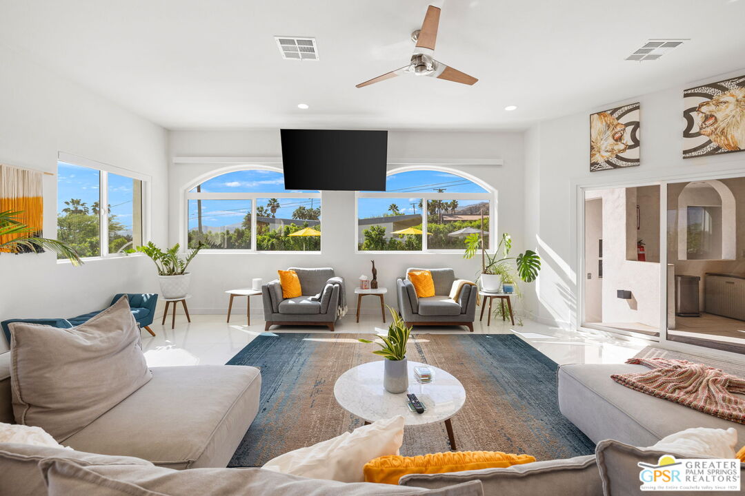 775 West Racquet Club Road Palm Springs, CA 92262 - Photo 19 of 44 a living room with fireplace furniture and a flat screen tv