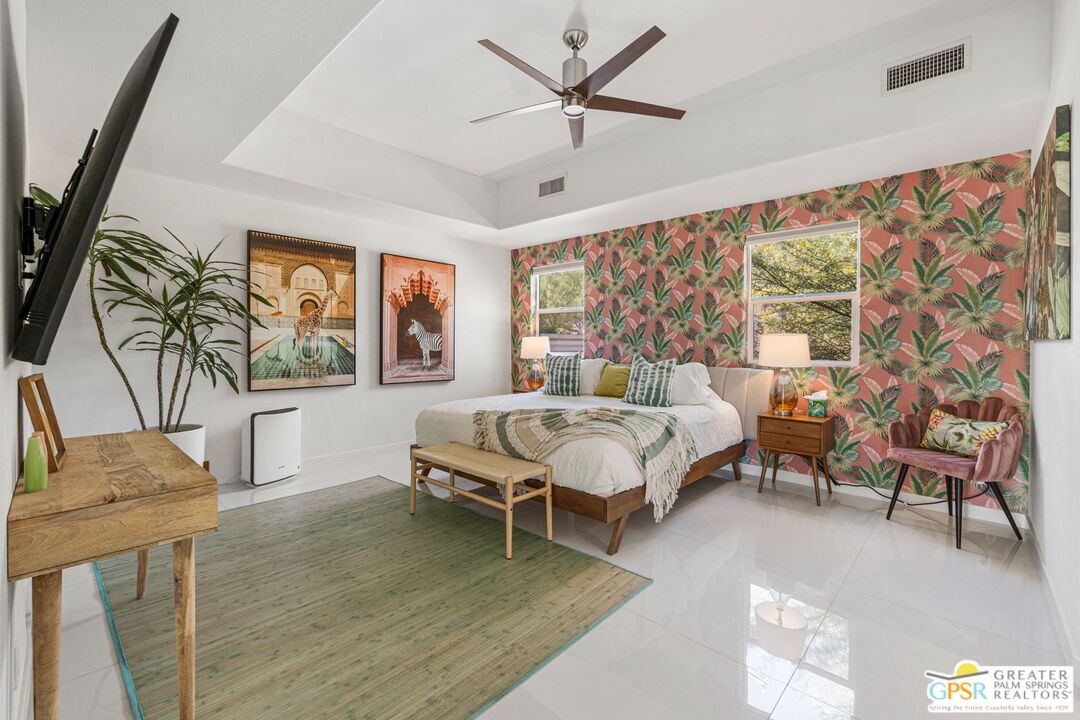 775 West Racquet Club Road Palm Springs, CA 92262 - Photo 22 of 44 a bedroom with a bed and a chandelier