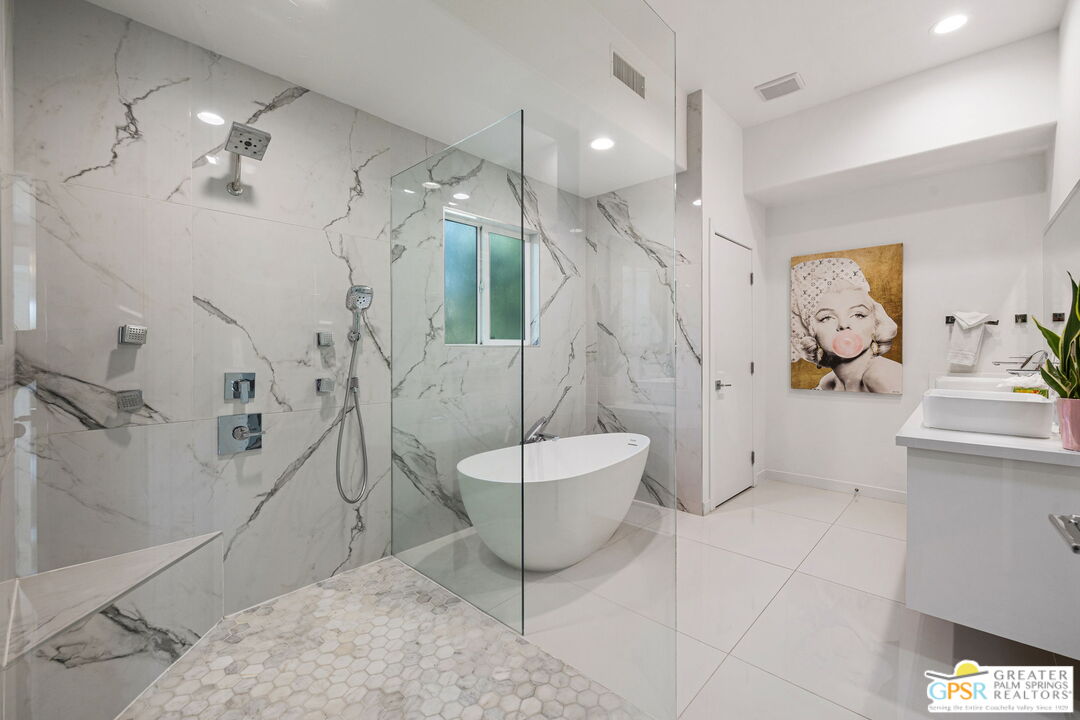 775 West Racquet Club Road Palm Springs, CA 92262 - Photo 23 of 44 a spacious bathroom with a bathtub and sink