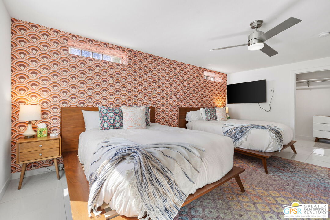 775 West Racquet Club Road Palm Springs, CA 92262 - Photo 30 of 44 a bedroom with bed and a chandelier