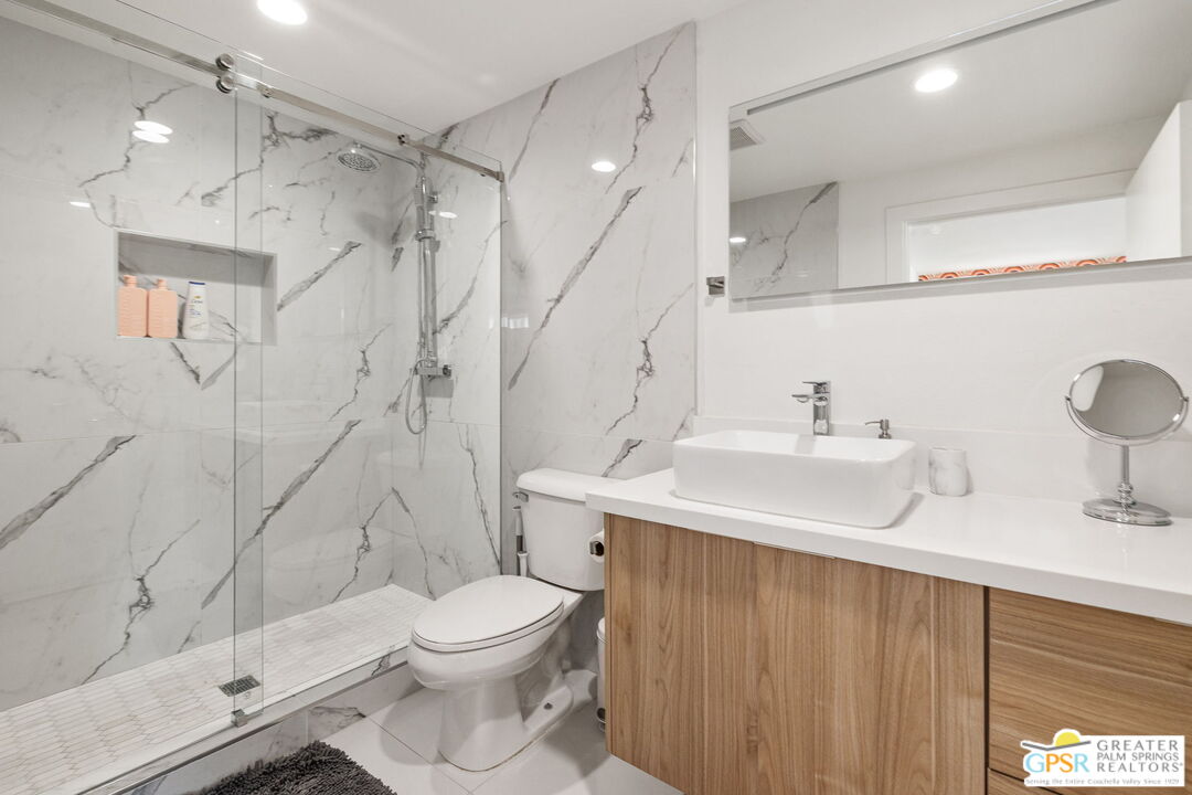 775 West Racquet Club Road Palm Springs, CA 92262 - Photo 32 of 44 a bathroom with a sink a toilet and shower