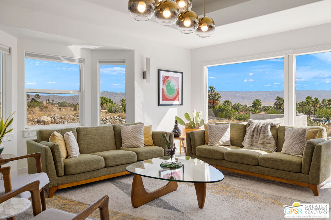 775 West Racquet Club Road Palm Springs, CA 92262 - Photo 8 of 44 a living room with furniture ceiling fan and a large window