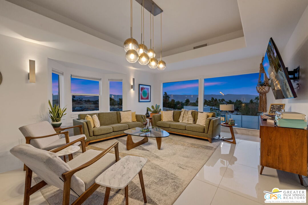 775 West Racquet Club Road Palm Springs, CA 92262 - Photo 9 of 44 a living room with furniture kitchen view and a chandelier
