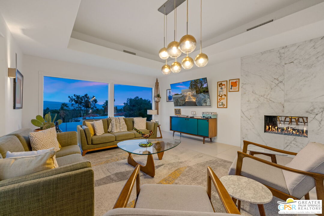 775 West Racquet Club Road Palm Springs, CA 92262 - Photo 10 of 44 a living room with furniture kitchen view and a chandelier