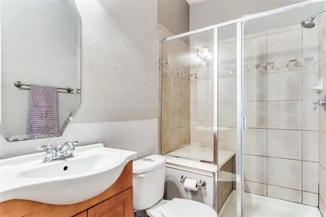 a bathroom with a sink toilet and shower