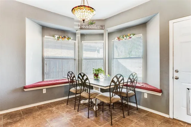 a view of a dining room with furniture and window