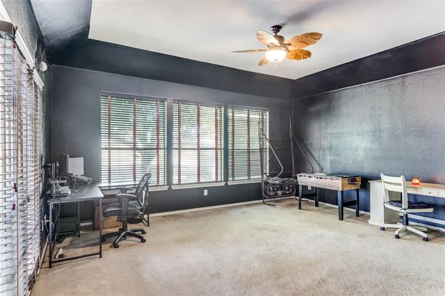 a workspace with furniture window and a ceiling fan