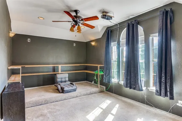 a bedroom with a bed and glass walk in closet