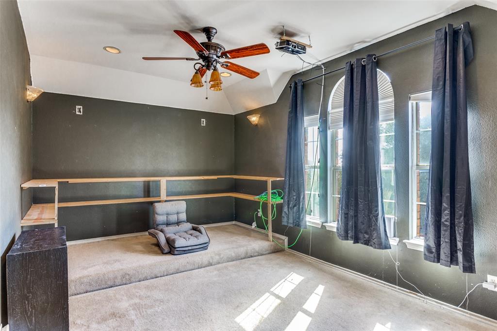 819 Hickory Street Burleson, TX 76028 - Photo 16 of 24 a bedroom with a bed and glass walk in closet