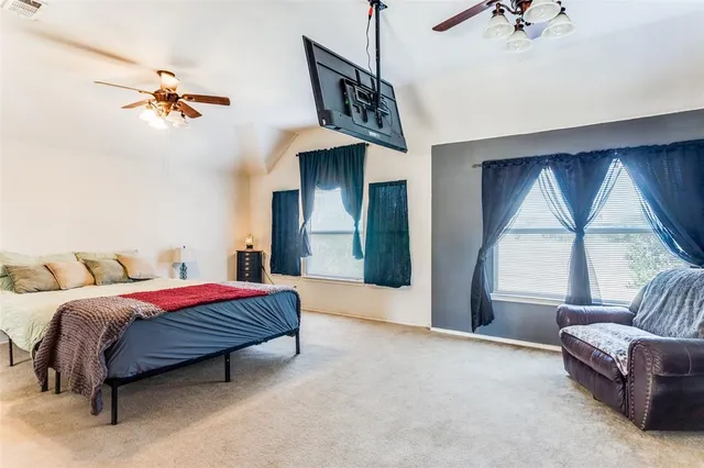 a living room with a bed furniture and a large window