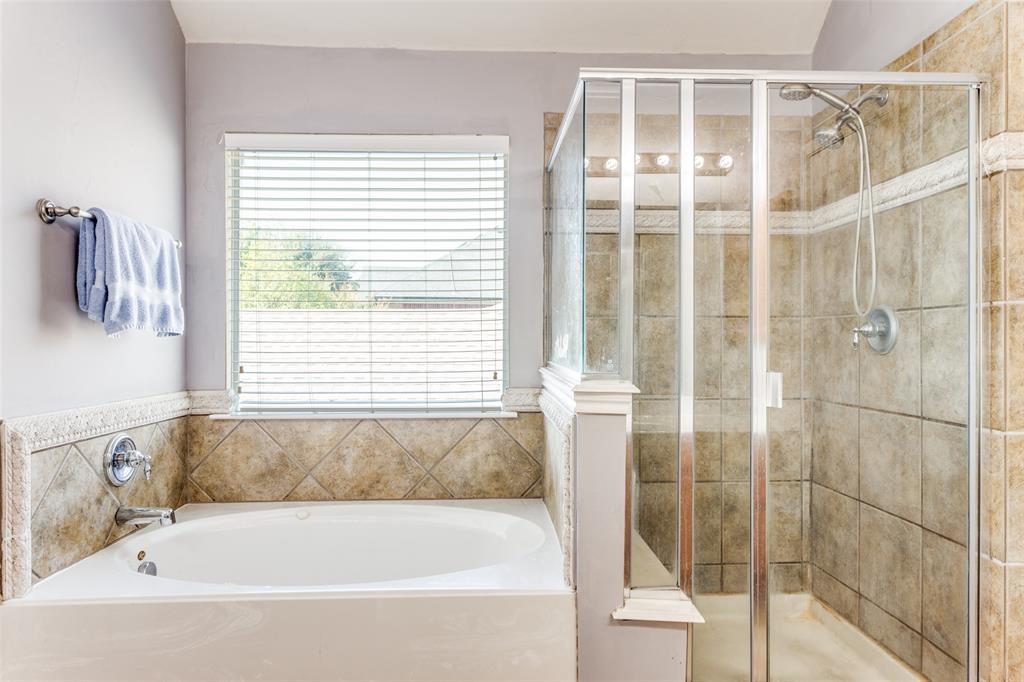 819 Hickory Street Burleson, TX 76028 - Photo 19 of 24 a bathroom with a bathtub and a shower