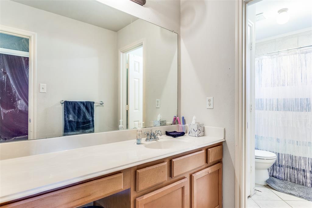 819 Hickory Street Burleson, TX 76028 - Photo 21 of 24 a bathroom with a sink and a mirror