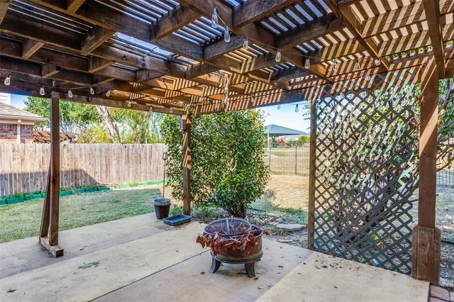 a car parked in front of a house with a yard