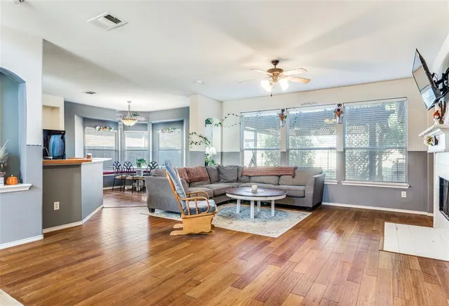 a living room with furniture and a wooden floor