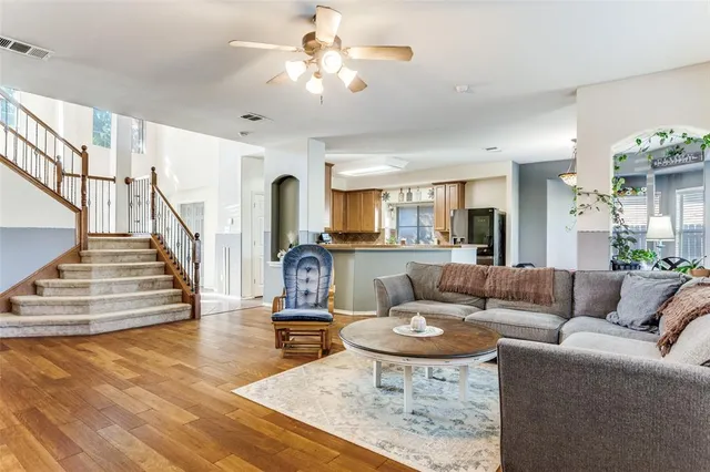 a living room with furniture and a dining table