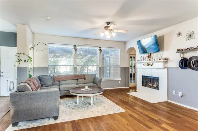 a living room with furniture a fireplace and a flat screen tv