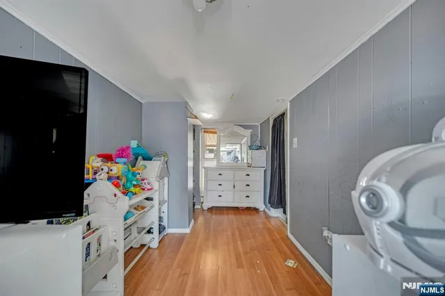 a view of a bedroom with bed and toys