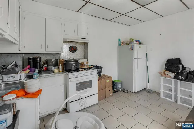 a kitchen with stainless steel appliances granite countertop a stove and a refrigerator