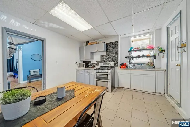 a kitchen with white cabinets and appliances