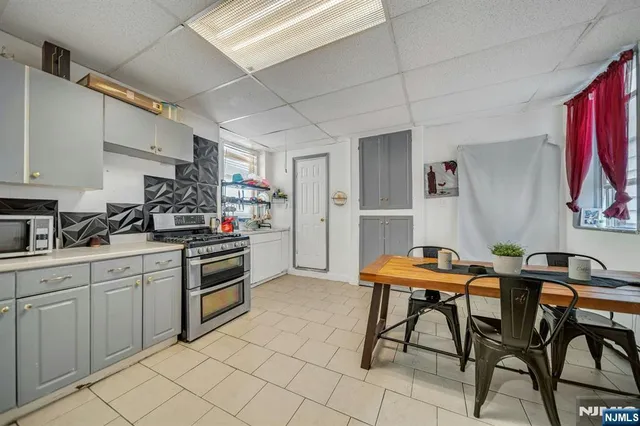 a kitchen with stainless steel appliances kitchen island granite countertop a sink and cabinets