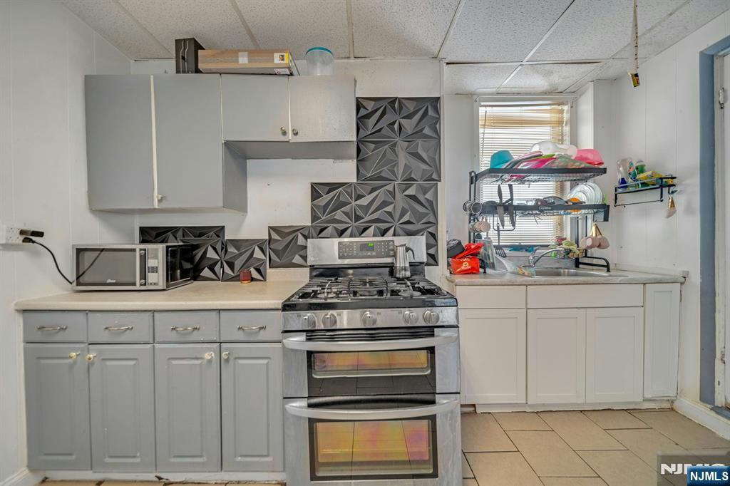 41 Heckel Street Belleville, NJ 07109 - Photo 6 of 38 a kitchen with white cabinets and appliances