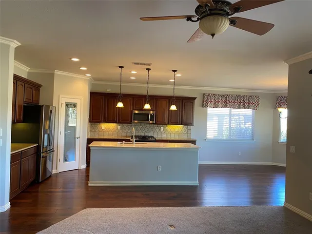 a view of a living room and a kitchen with a window